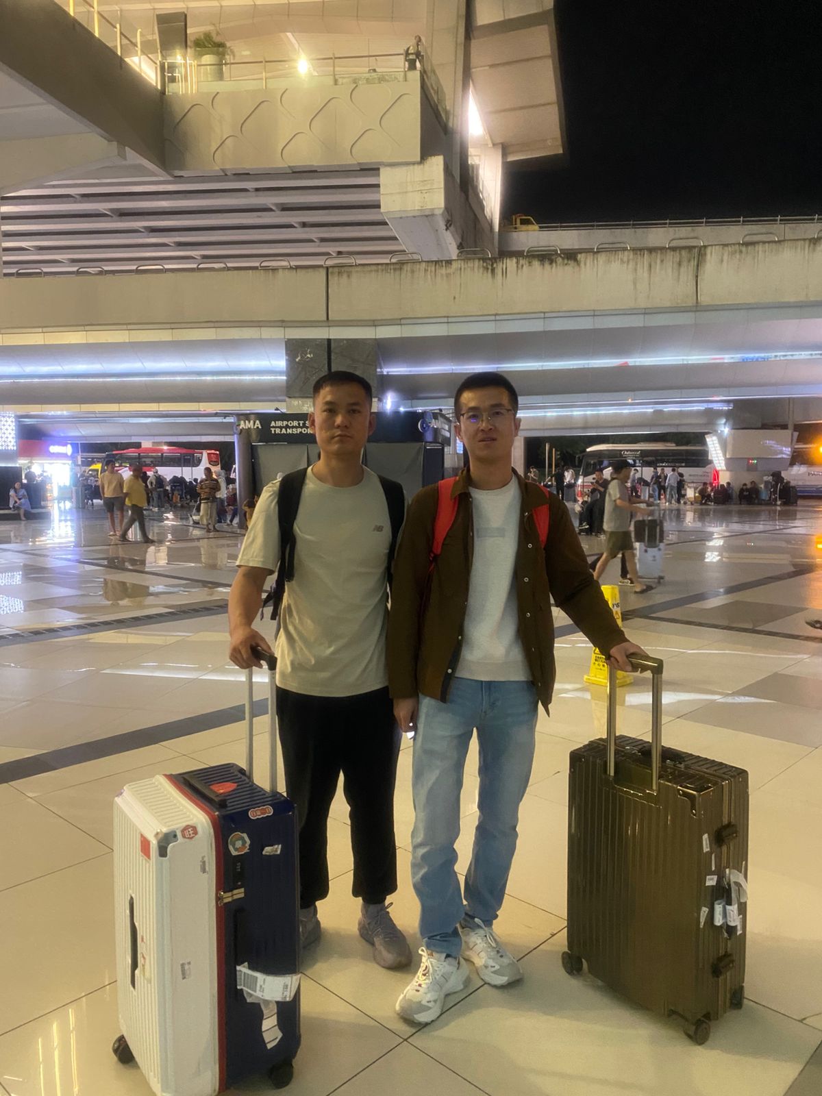 Two crew members arriving for sign-on operations for MT SC Shanghai at Port of Merak, Indonesia, supported by TMA Shipping's husbandry and crew change services.