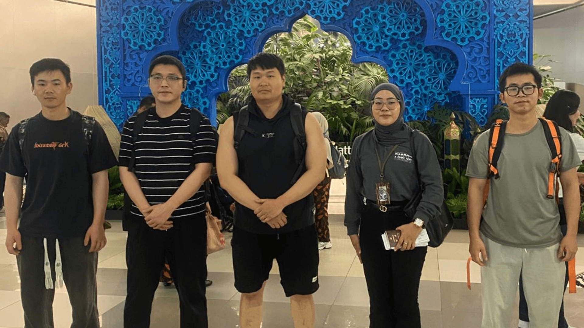 Seafarers completing crew sign-off procedures at Sulfindo Terminal, escorted by an Indonesian immigration officer for international departure